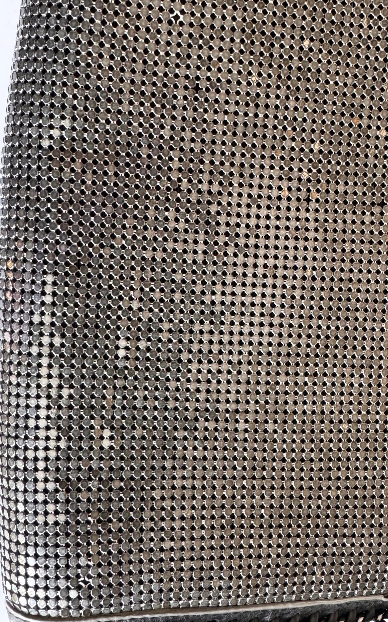 BCBG Max Azria gunmetal metal mesh clutch with leather whipstitch trim and tassel