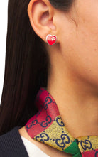 Gucci interlocking G heart stud earrings worn on model