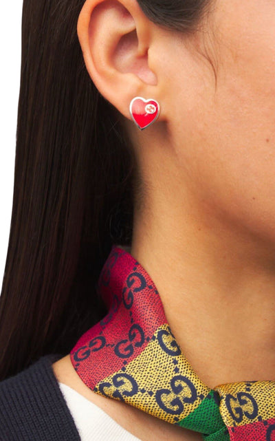Gucci interlocking G heart stud earrings worn on model