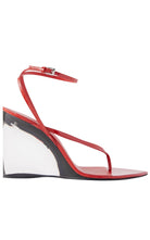 Alaia -a red patent leather thong sandal with a clear wedge heel and an adjustable ankle strap, shown from a side profile on a white background.