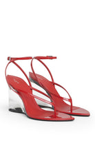 Alaia a pair of red patent leather thong sandals with clear wedge heels, shown against a plain white background.