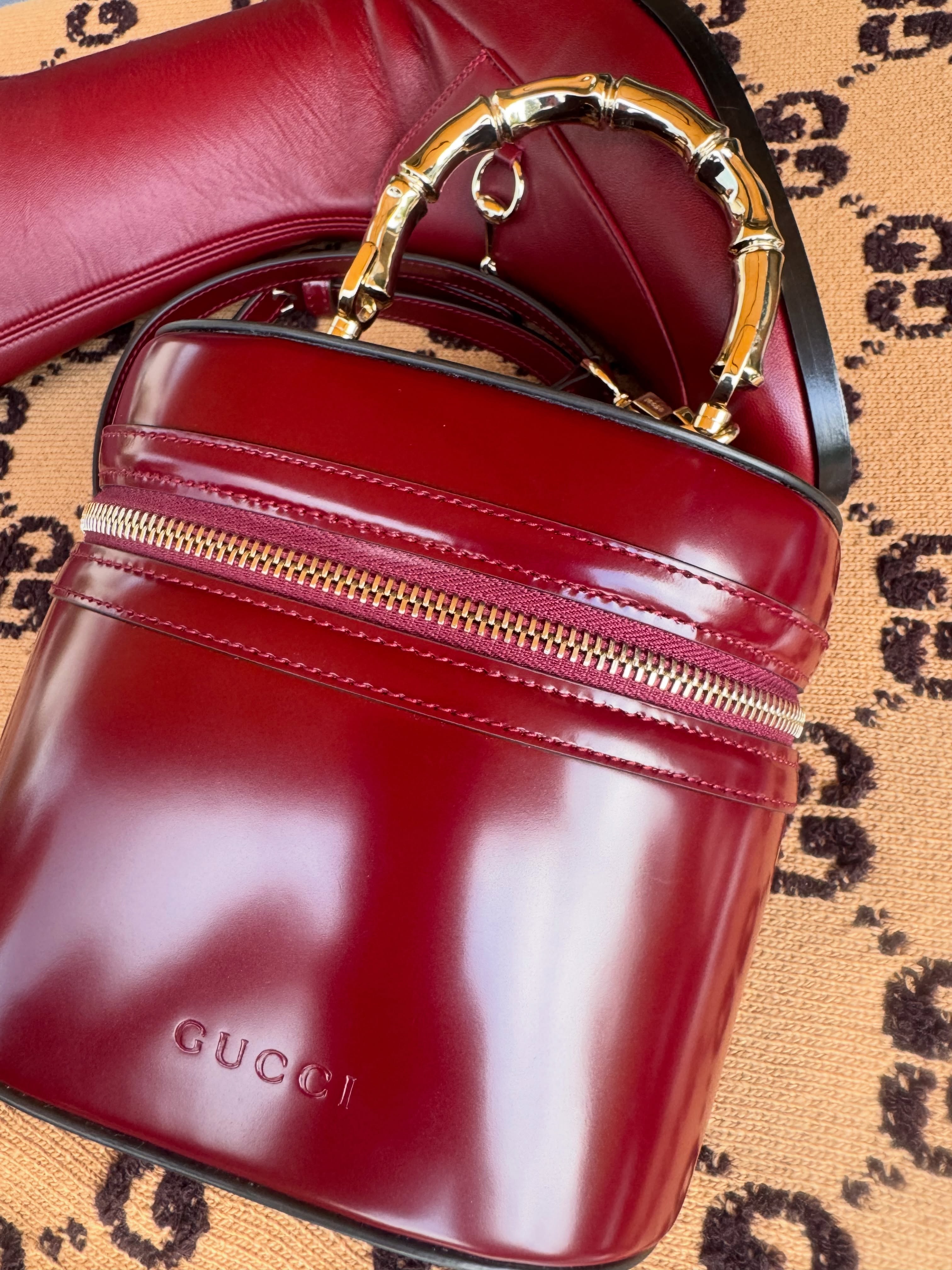 Gucci burgundy glossy leather bucket bag with bamboo-inspired top handle