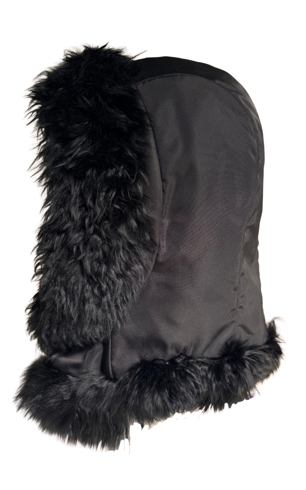 A black Prada winter trapper hat featuring a textured fabric body and fluffy black faux fur trim on the ear flaps and brim, shown against a plain white background.