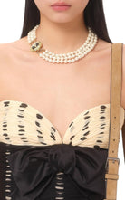 Detail view of Valentino silk chiffon top with handmade draping and bow